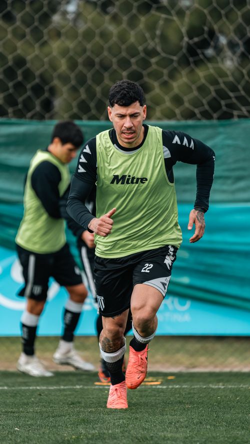 Free Male soccer player performing drills during an outdoor training session on the field. Stock Photo