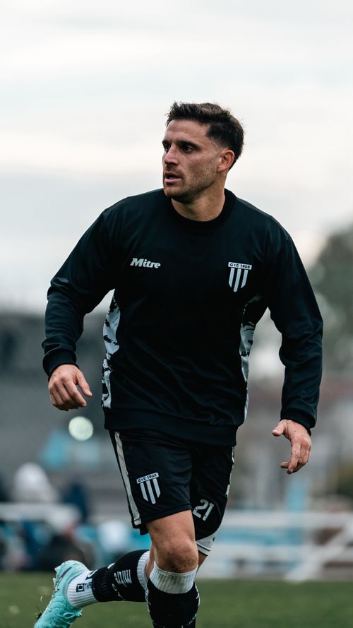 Free Athletic male soccer player in action on an outdoor field during daytime. Stock Photo