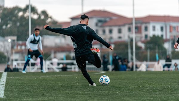 Footballer striking the ball at a training ground