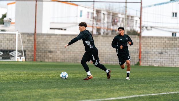 A professional scout analyzing game footage to assist in identifying athletic potential.
