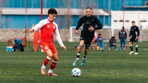 Free Two soccer players in intense action on a green field during a match. Stock Photo