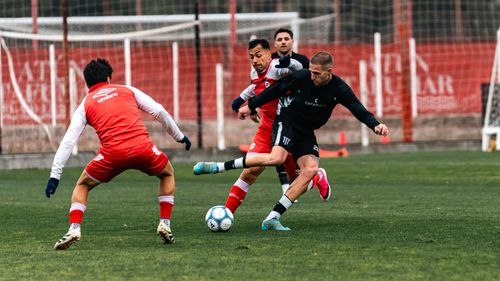 Free Intense soccer match with players competing on a green field, showcasing athleticism and teamwork. Stock Photo