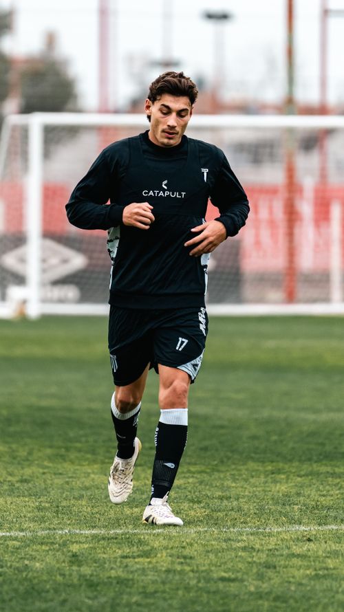 Free Male soccer player training outdoors in athletic gear, showing athletic determination. Stock Photo
