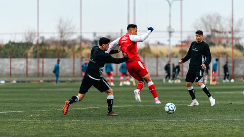 Free Action-packed soccer match with players in dynamic movement on a green field. Stock Photo