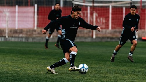 Free Dynamic shot of adult male soccer players in action during a match on a grass field. Stock Photo