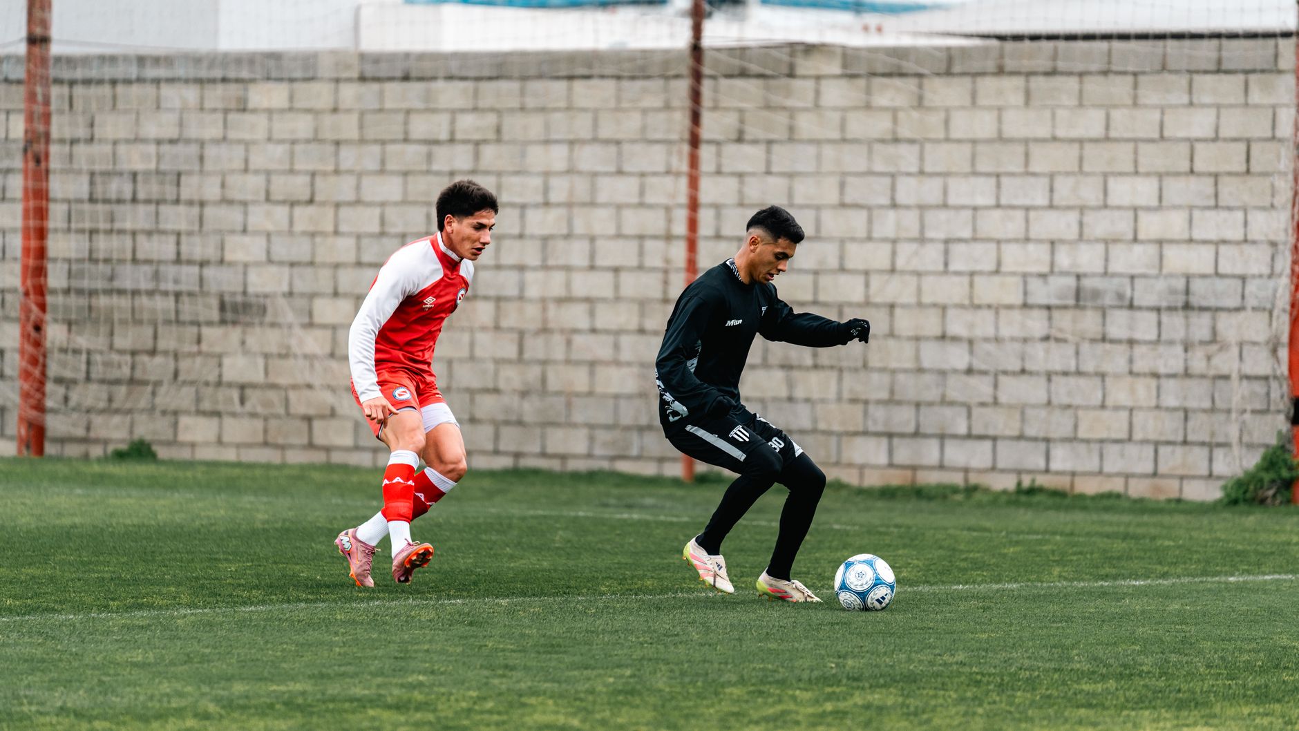Algeria and Austria players contesting a tense World Cup group match under bright Kansas City stadium lights