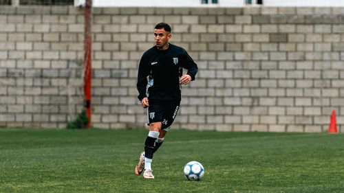Free A soccer player in motion during practice on an outdoor field. Stock Photo