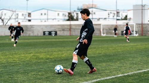 Free A young male soccer player in action on a grassy field during practice. Stock Photo