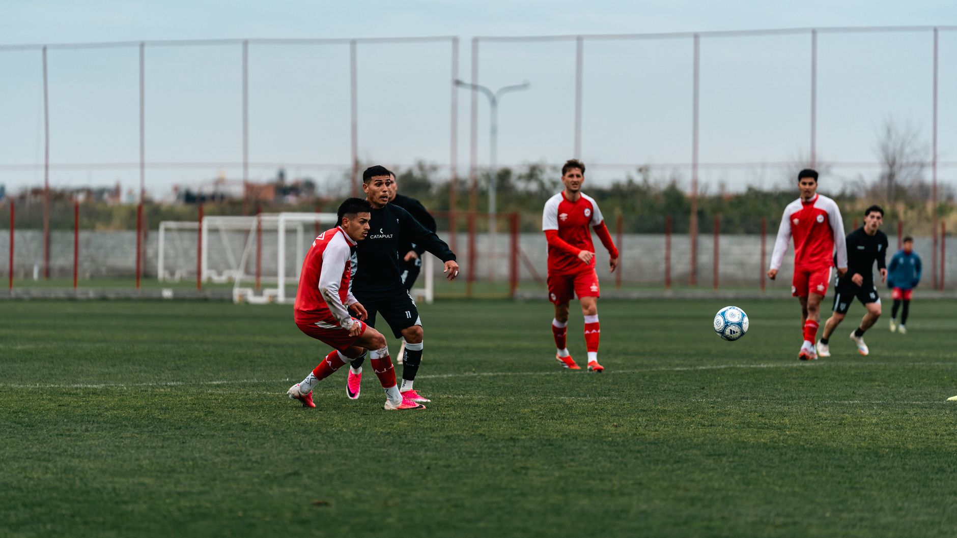 Algeria players rehearsing a defensive transition drill on a sunlit training pitch before a qualifier