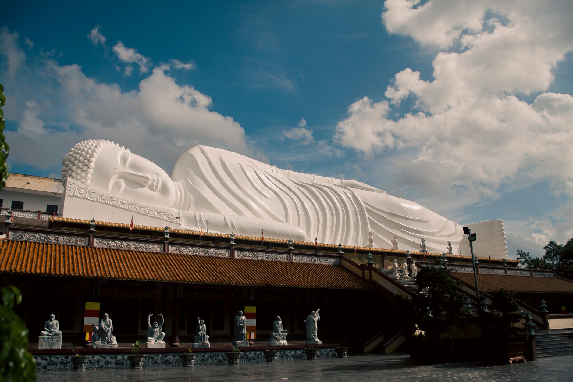 Majestic Reclining Buddha statue under a summer sky in Ho Chi Minh City, Vietnam.