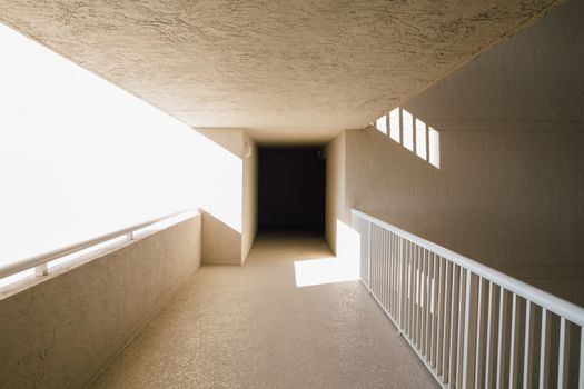 Empty hallway of modern light building with concrete walls and balcony with bright sunlight. empty, hallway, modern