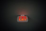Exit sign hanging on ceiling in public area