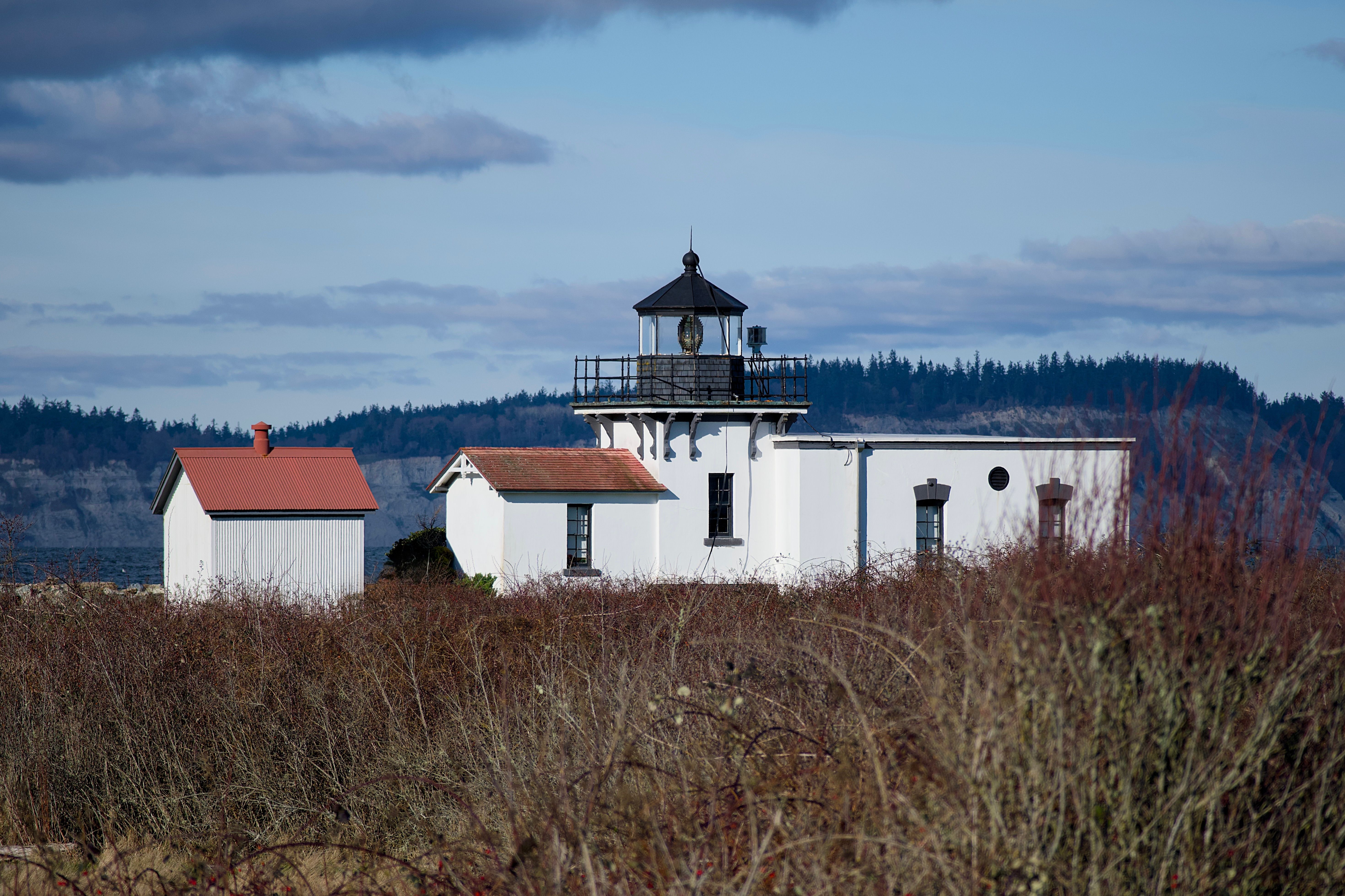 Point No Point Lighthouse surrounded by coastal landscape in Hansville, WA.