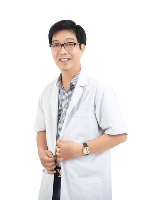 Free Smiling male doctor in a white coat with glasses, isolated on white background. Stock Photo