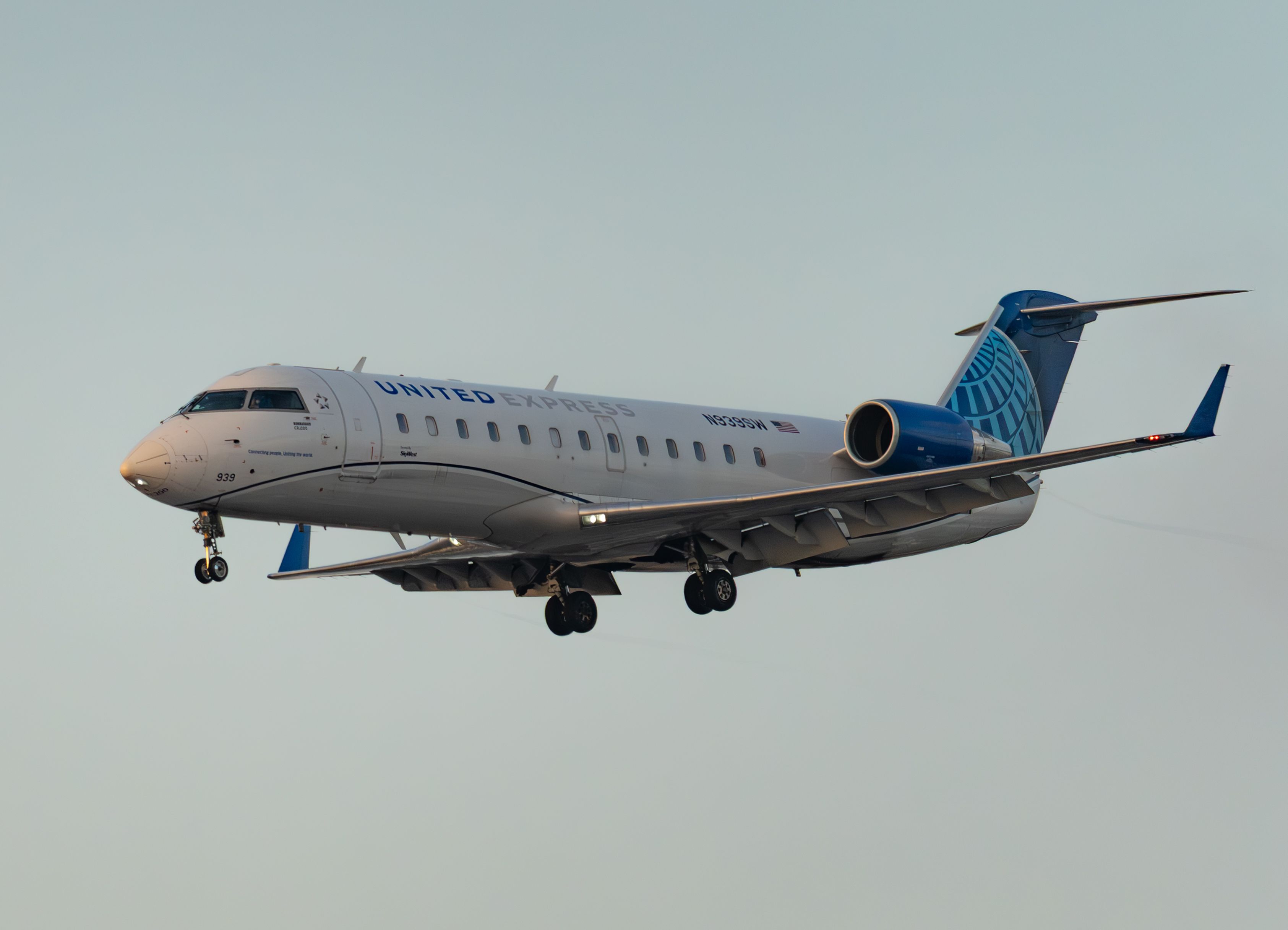 United Express jet captured flying against a clear sky, showcasing aviation in action.