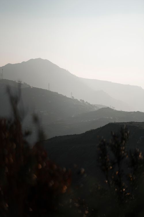 Free Peaceful mountain ridges layered in soft evening light, creating a tranquil and atmospheric scene. Stock Photo