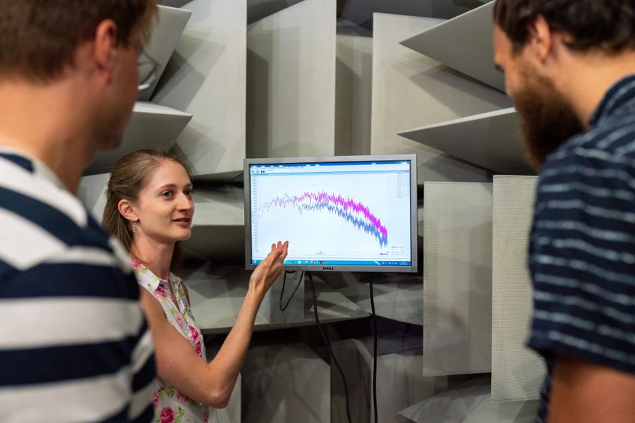 Two engineers reviewing a frequency spectrum on a monitor