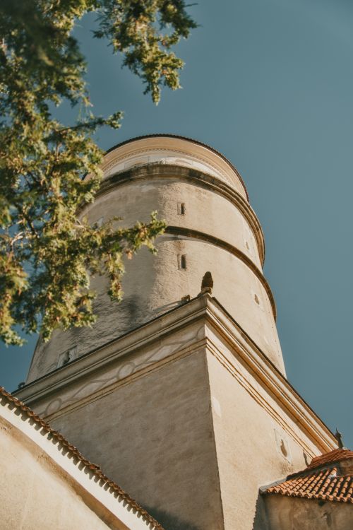 Free View of an ancient tower with clear blue sky background and greenery framing. Stock Photo