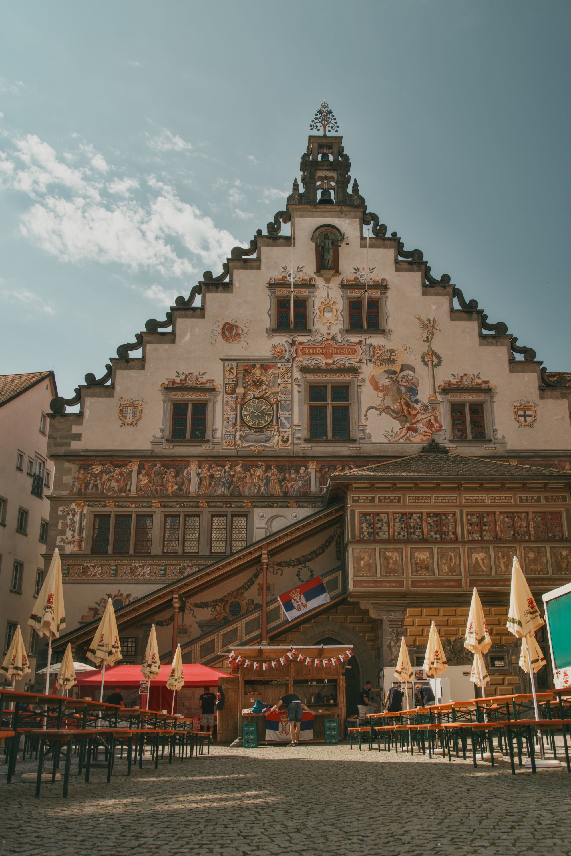 Historical German building with intricate facade in a lively old town square.