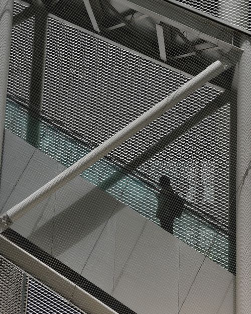 Free Silhouette of a person walking on a modern industrial walkway in Taiwan, emphasizing architectural design. Stock Photo