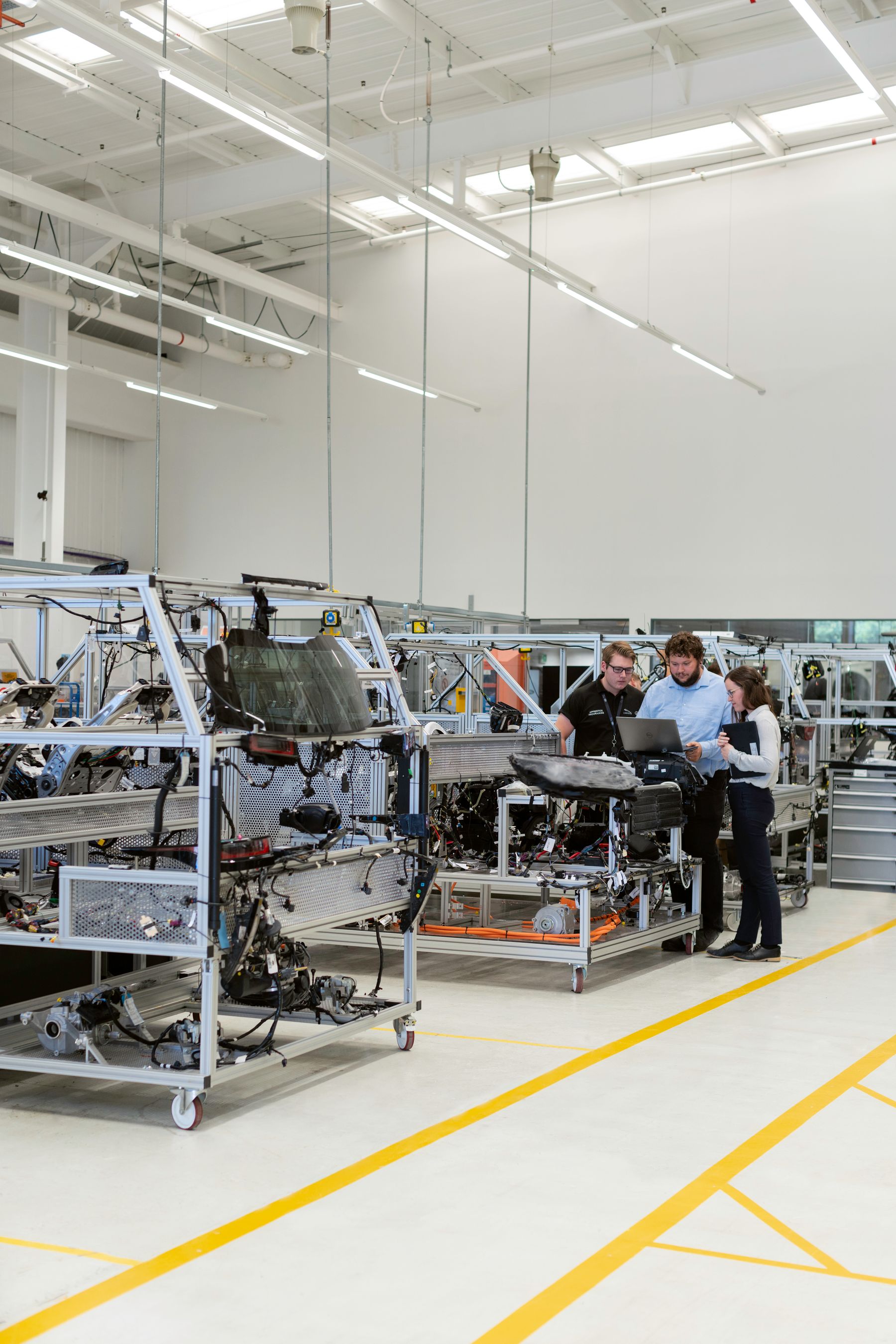 Engineers discussing technical work in an industrial workshop