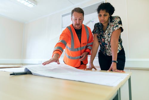 Engineers Looking at Blueprint