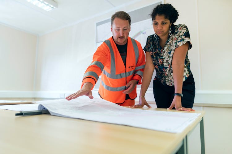 Engineers Looking At Blueprint