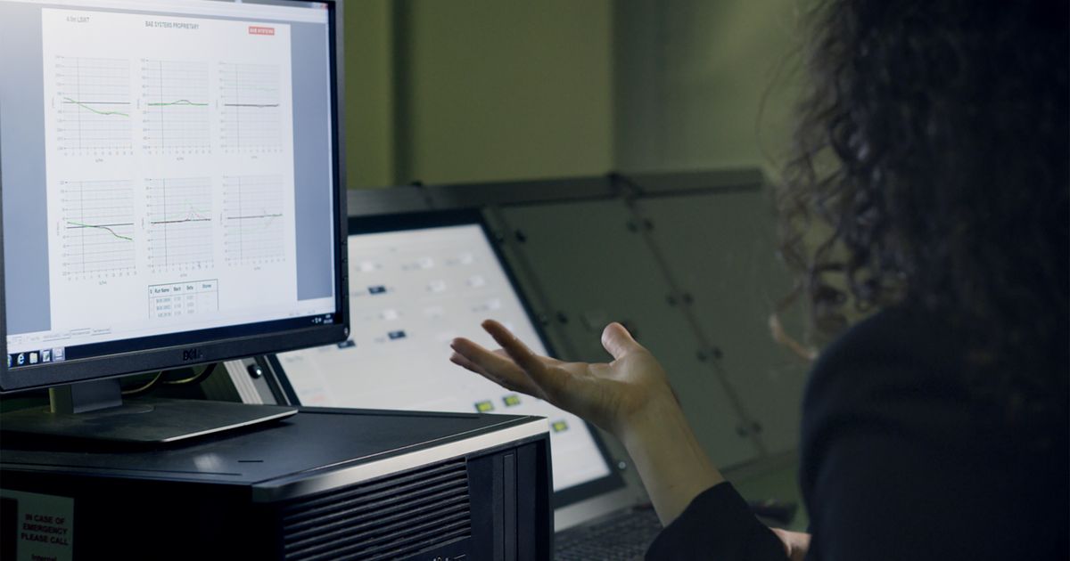 A woman analyzing data on a computer screen in a modern office