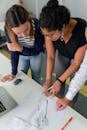 Photo Of Women Analyzing Work