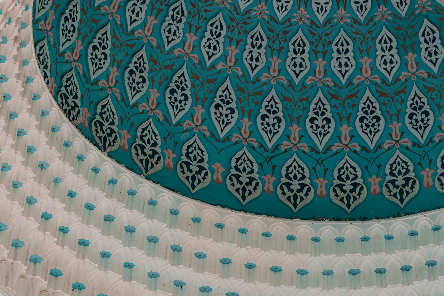 Detailed view of intricate Islamic patterns on a turquoise dome in Tashkent, Uzbekistan.