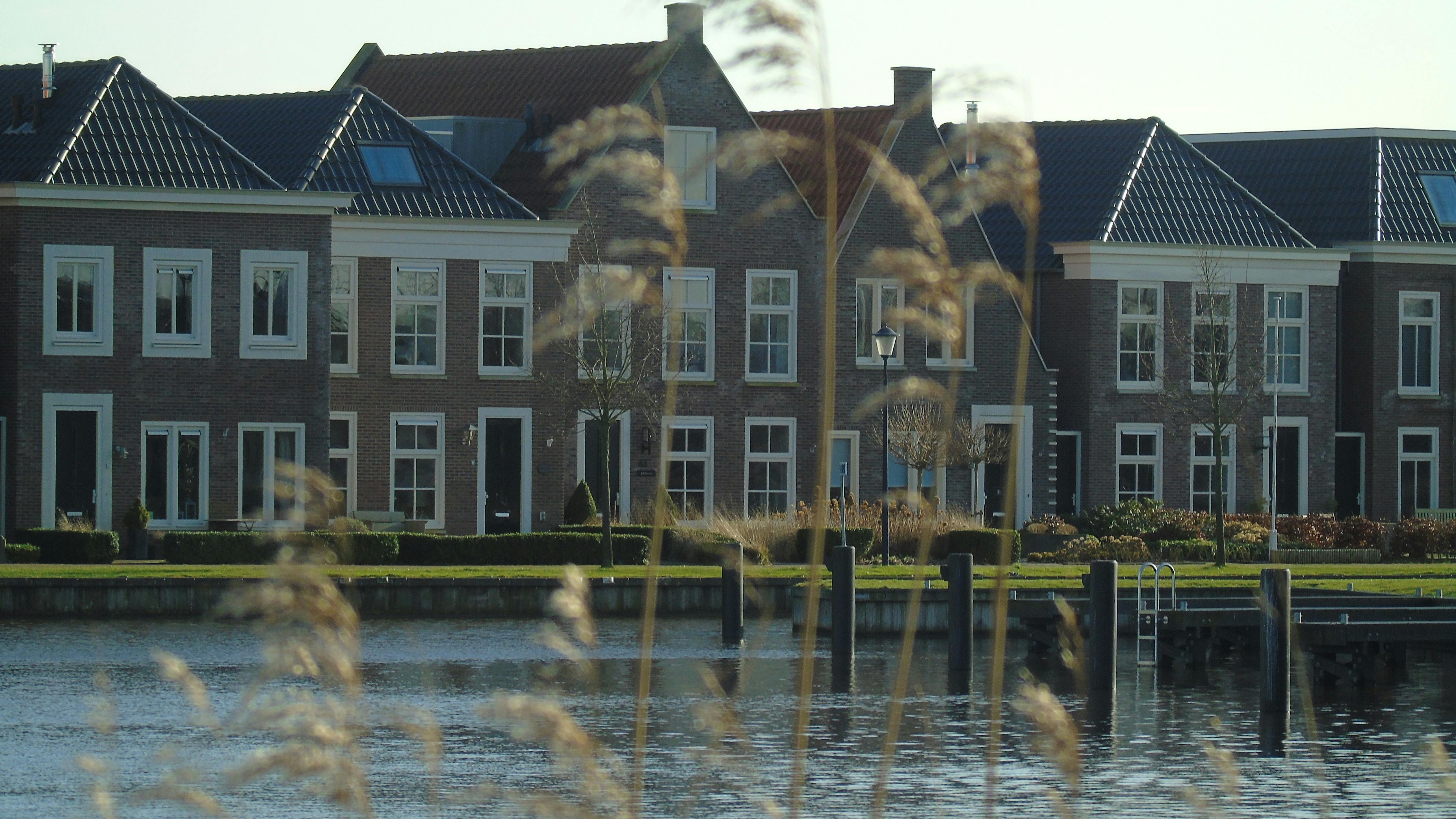 A caregiver providing health assistance to an elderly person in their home.