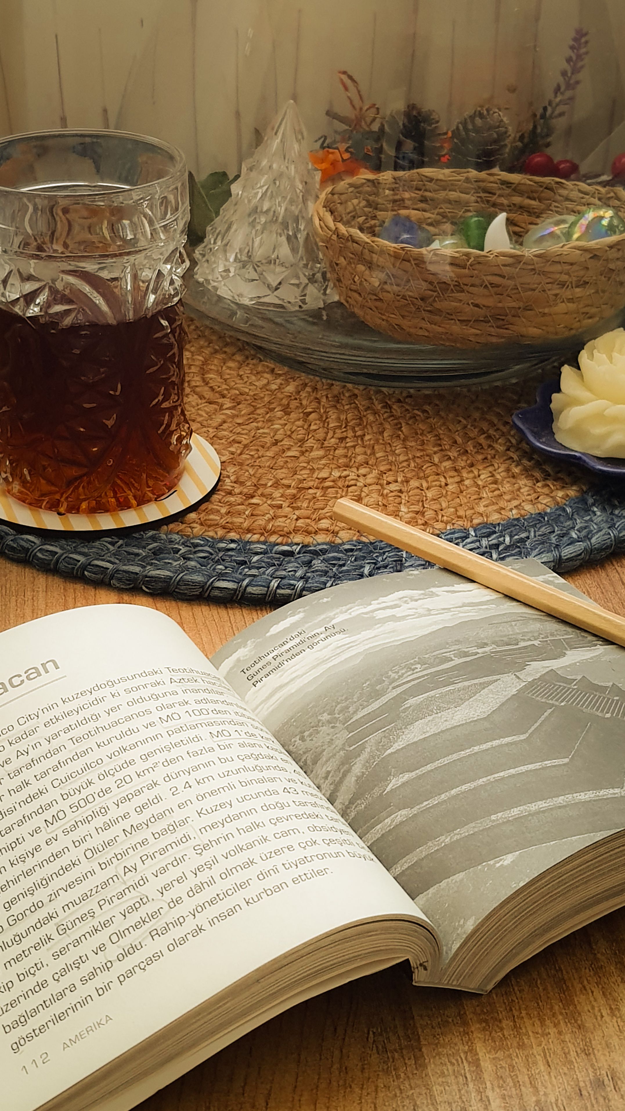 A warm and inviting setting with tea and an open book, ideal for relaxation.
