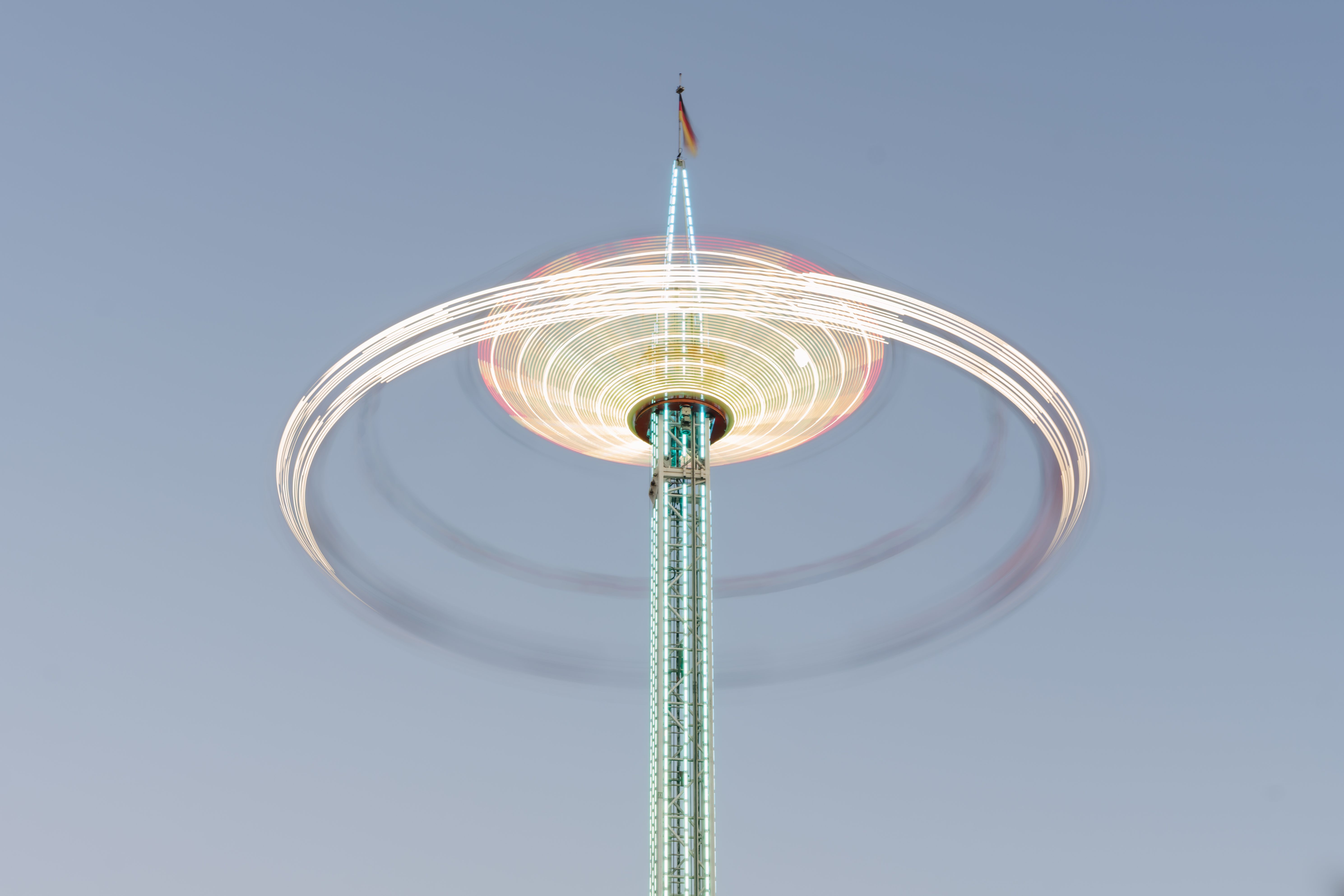 A thrilling night shot of a spinning amusement ride with colorful lights in Geldern, Germany.