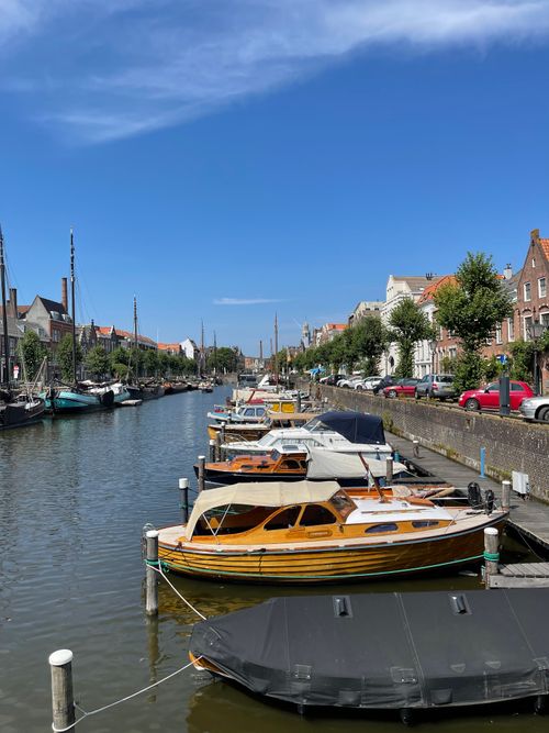 Free A picturesque canal with boats and historic buildings in Europe. Stock Photo