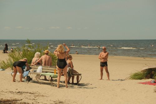 Free A group of people enjoying a sunny day on the beach in Jūrmala, Latvia. Stock Photo