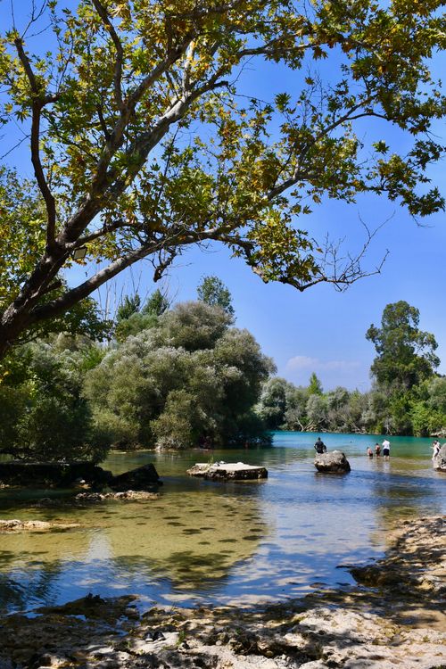 Free Peaceful river landscape in Antalya with lush greenery and clear water on a sunny day. Stock Photo