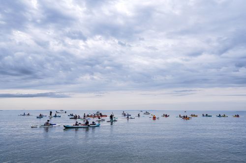 Free A group of kayakers paddle on a tranquil sea under a cloudy sky in Stamford, CT. Stock Photo
