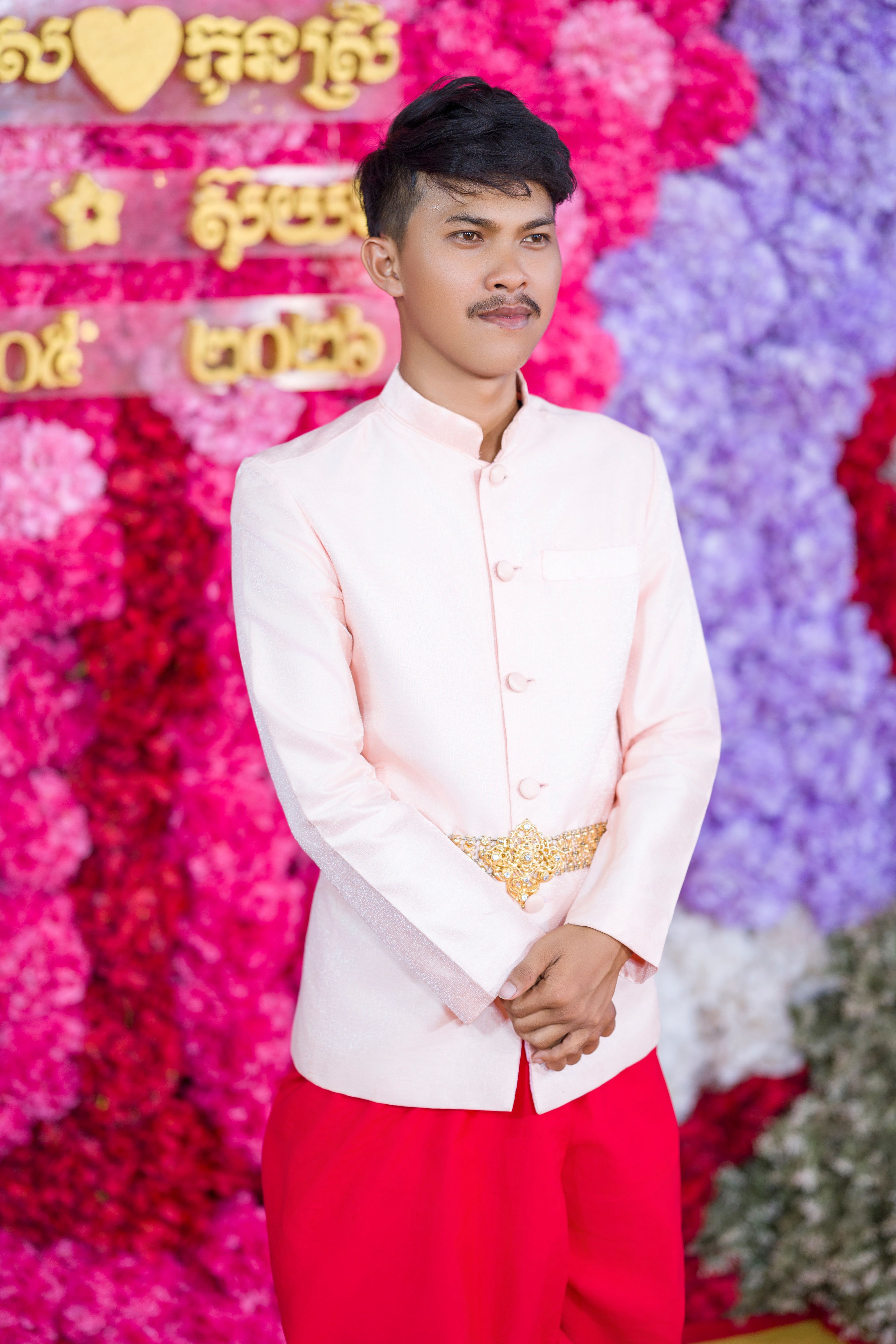 Elegant portrait of a man in traditional Khmer attire at a Cambodian wedding ceremony.