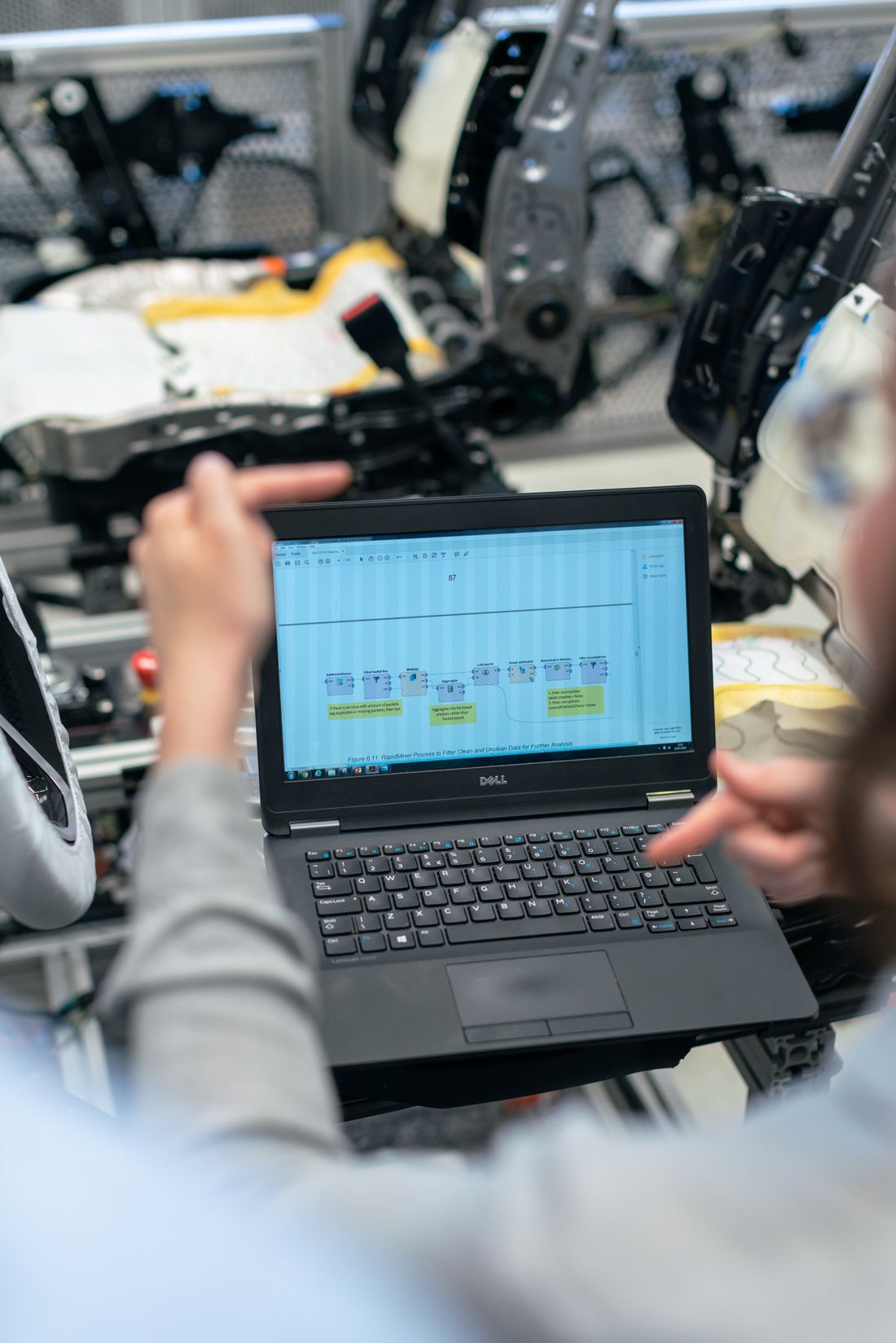 Engineers reviewing technical data at an automotive workshop