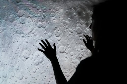 Woman Studying Moon Surface