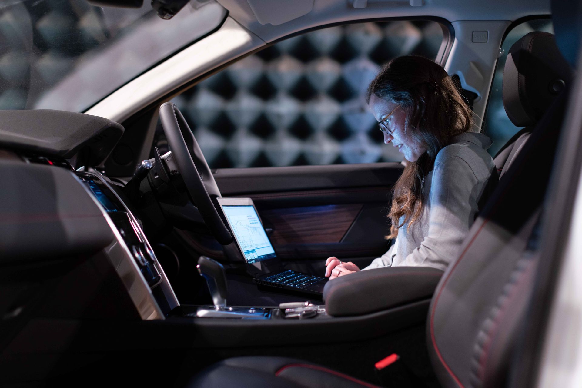 Female Engineer using Laptop Inside a Car