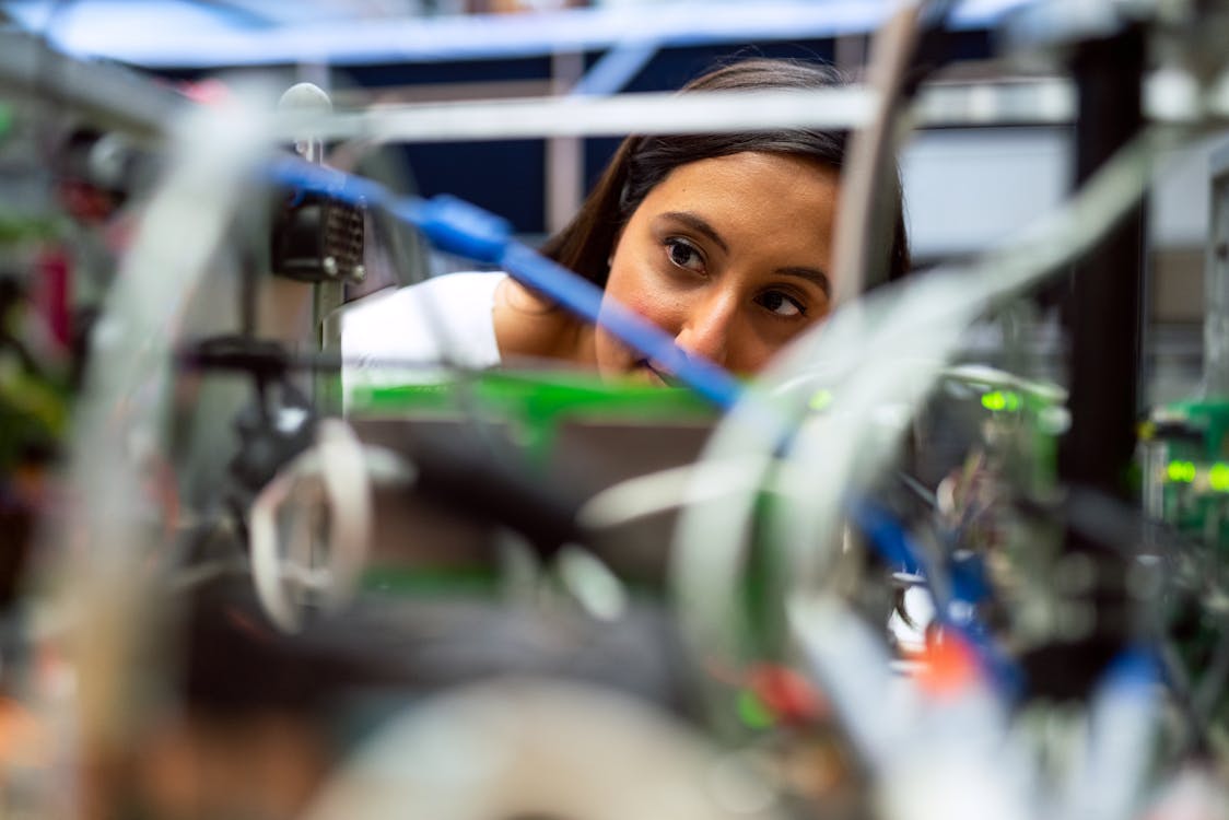 Photo Of Female Engineer Looking Through Wires