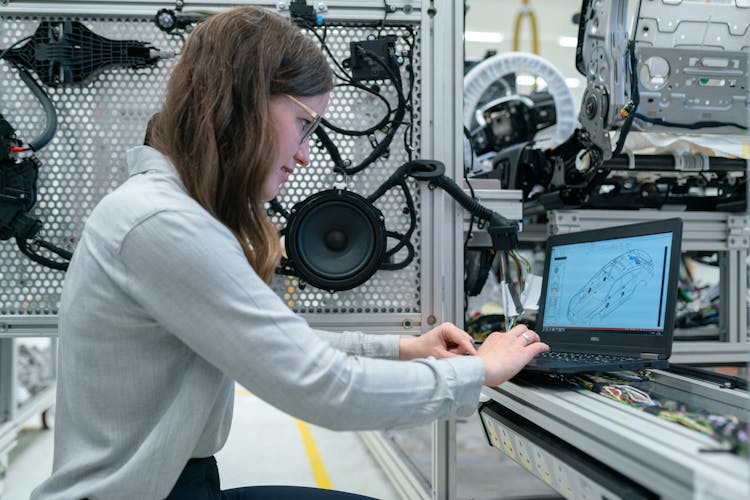 Female Engineer Working In Workshop