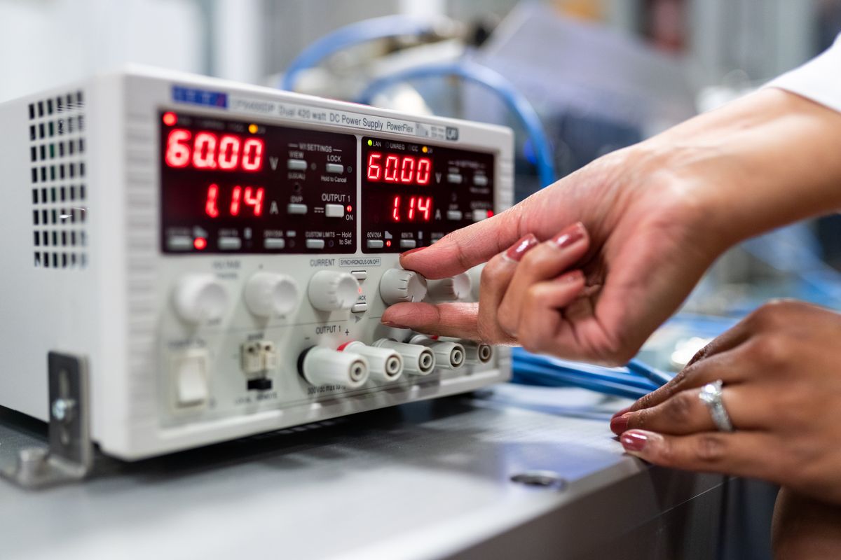 Engineer working with precision measurement equipment in a laboratory setting