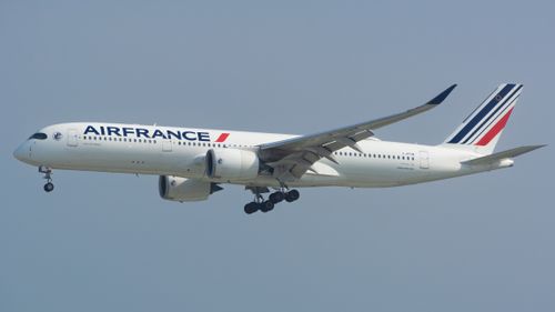 Free Air France Airbus A350 flying against a clear blue sky, showcasing modern aviation. Stock Photo