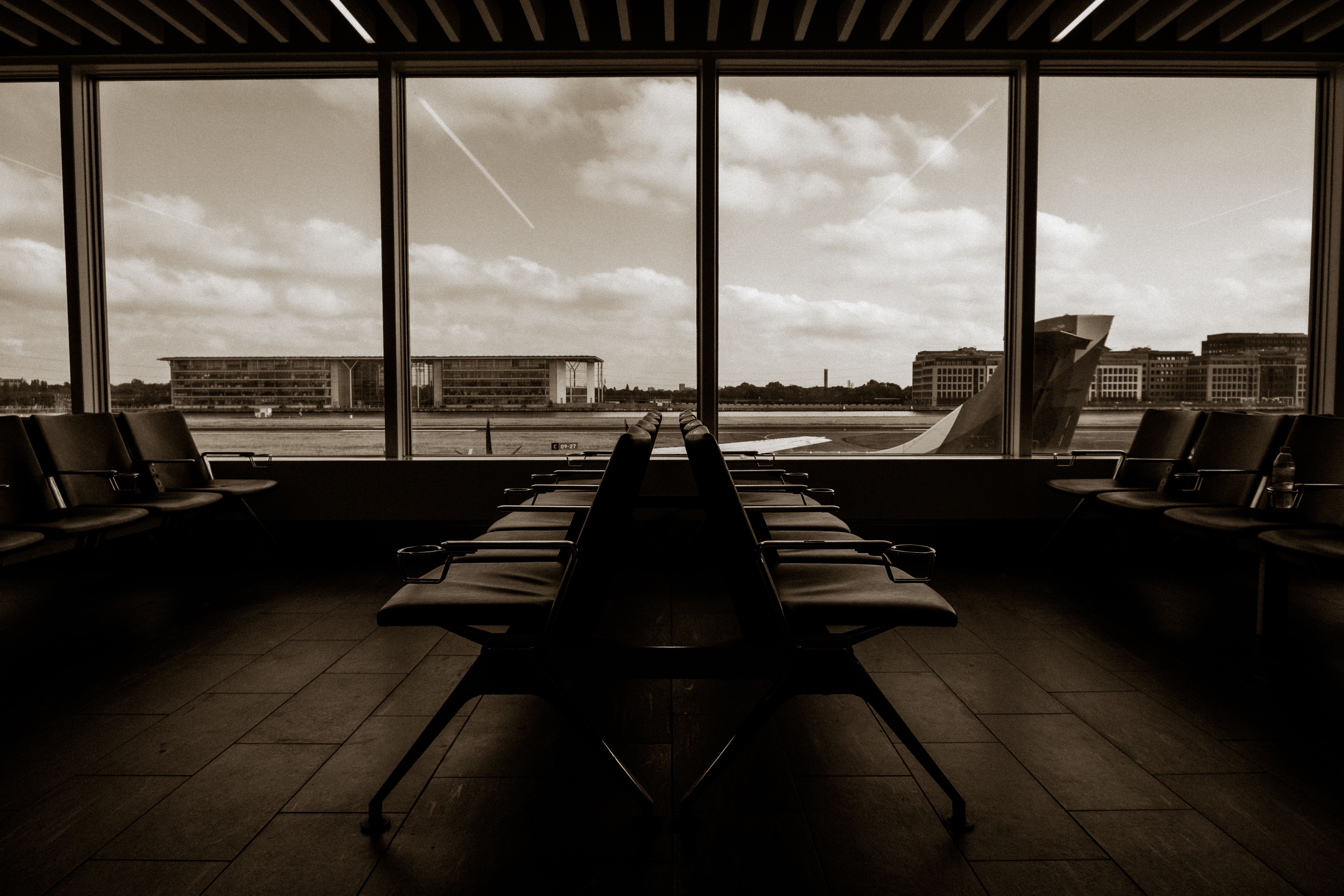 A minimalist luxury private airport terminal with integrated biometric scanners and a sleek, high-tech aesthetic.