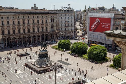 Free Dynamic aerial view of Piazza del Duomo with historic architecture and lively crowd. Stock Photo