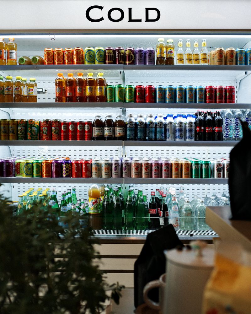 A vibrant array of drinks showcased in a cold beverage refrigerator in Houston, TX
