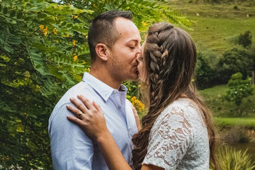 Romantic couple kissing in blooming garden