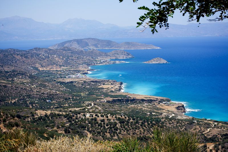 Rugged north coast of Crete with a bright blue sea under a clear sky